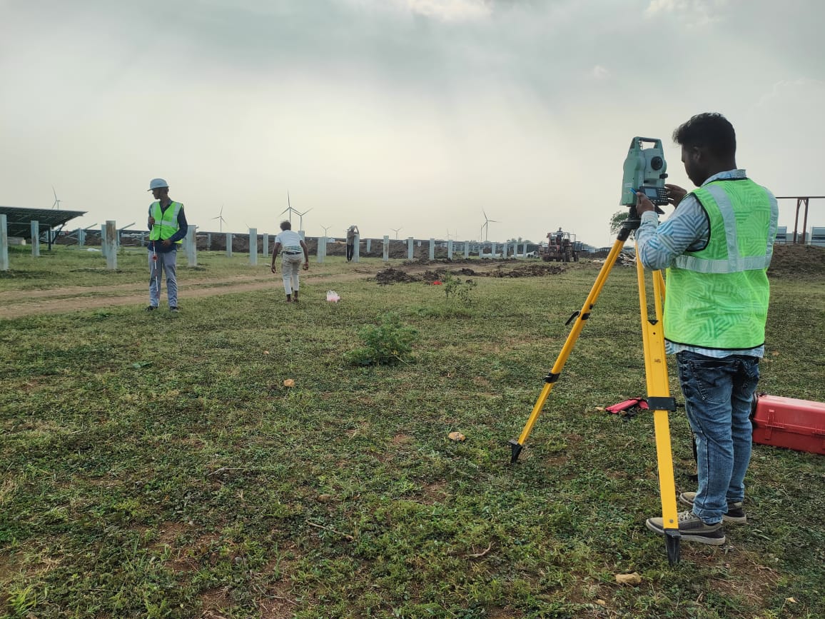 Surveyor loading coordinate data on total station for solar park stakeout