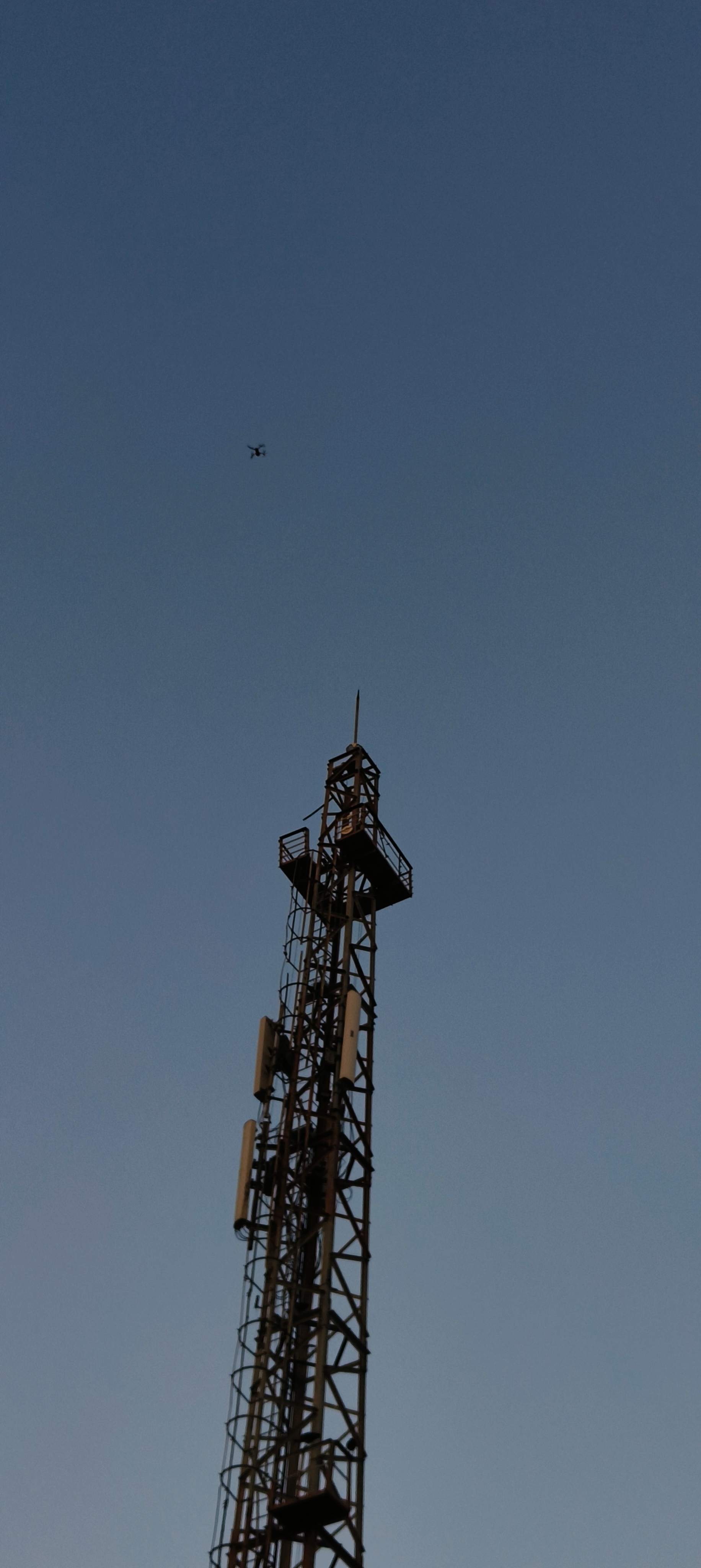 Drone scanning a mobile tower structure for inspection